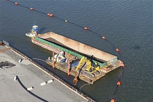 Dredging of approximately 2,000 cubic yards of sediment from along the shoreline of the former Roosevelt Drive-in site was completed in August by a mechanical dredge working from barges in the River.